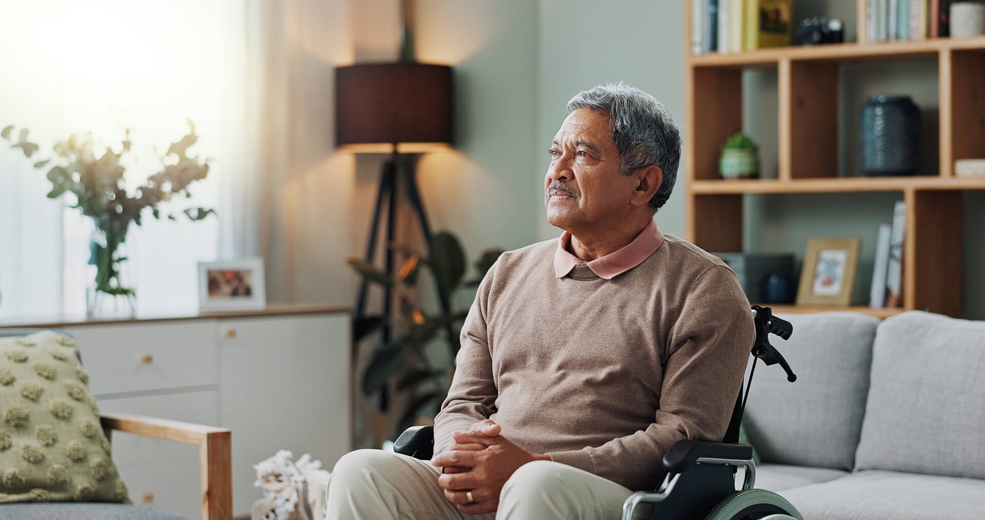 A patient sitting in a bright, comfortable space looking off to the left, deep in thought. Models are used for illustrative purposes only.
